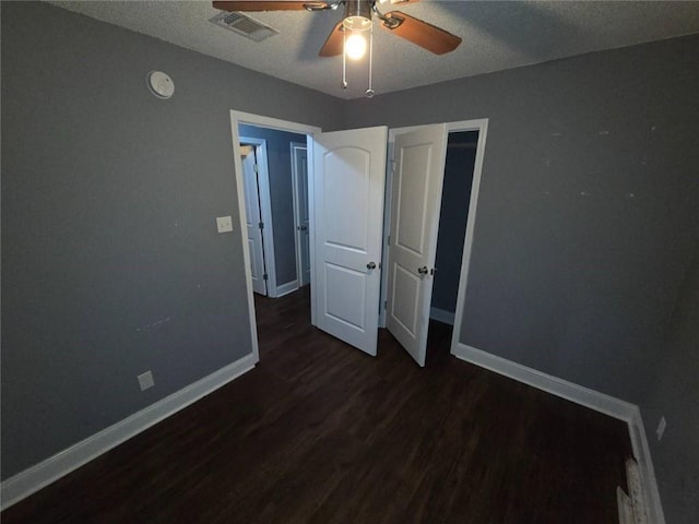 1105 Adams St, Mobile, AL 36603 - unfurnished bedroom with wood finished floors, a textured ceiling, and a ceiling fan