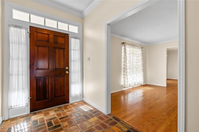 foyer entrance featuring crown molding, dark hardwood / wood-style flooring, and a textured ceiling