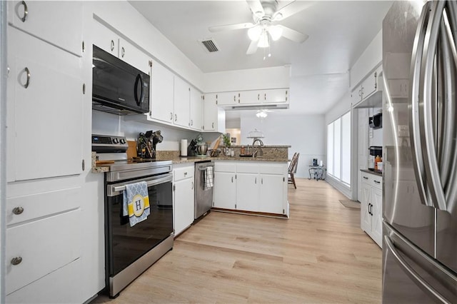 5554 Racine Ave, Mobile, AL 36618 - kitchen featuring stainless steel appliances, white cabinetry, ceiling fan, and light wood-style flooring