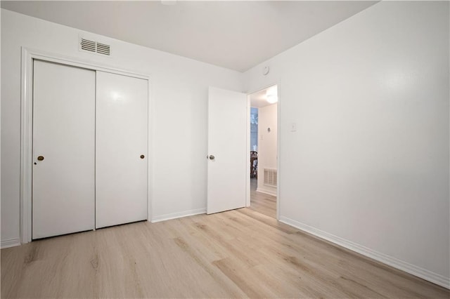 5554 Racine Ave, Mobile, AL 36618 - unfurnished bedroom featuring wood finished floors and a closet
