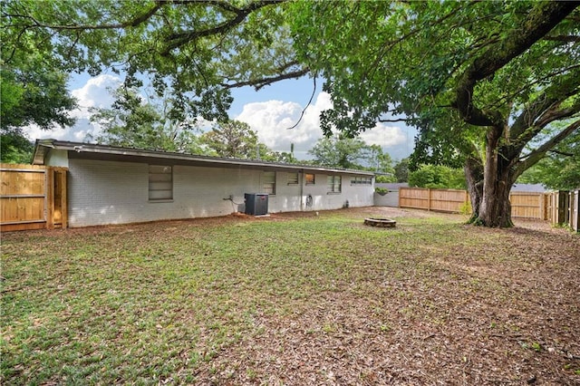 5554 Racine Ave, Mobile, AL 36618 - back of house with brick siding, a fenced backyard, and a fire pit