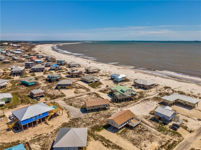 birds eye view of property featuring a water view and a beach view