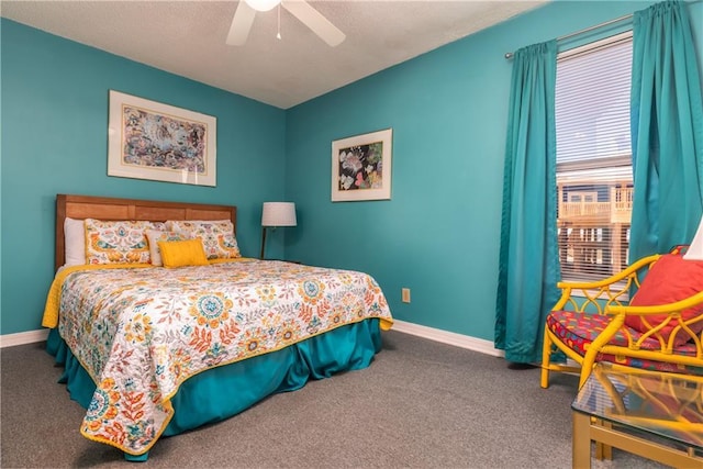 bedroom featuring ceiling fan, a textured ceiling, baseboards, and carpet