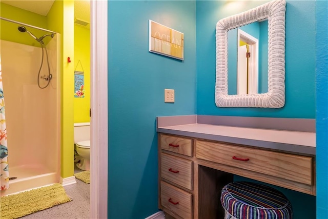 bathroom featuring vanity, visible vents, speckled floor, a shower stall, and toilet