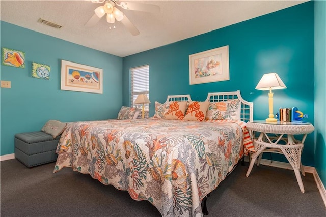 carpeted bedroom with visible vents, ceiling fan, a textured ceiling, and baseboards