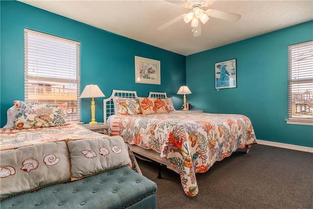 carpeted bedroom with baseboards and a ceiling fan