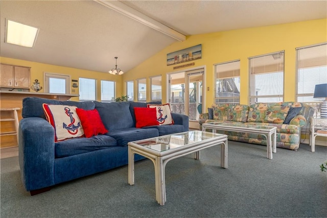 living room featuring a healthy amount of sunlight, vaulted ceiling with beams, an inviting chandelier, and carpet floors