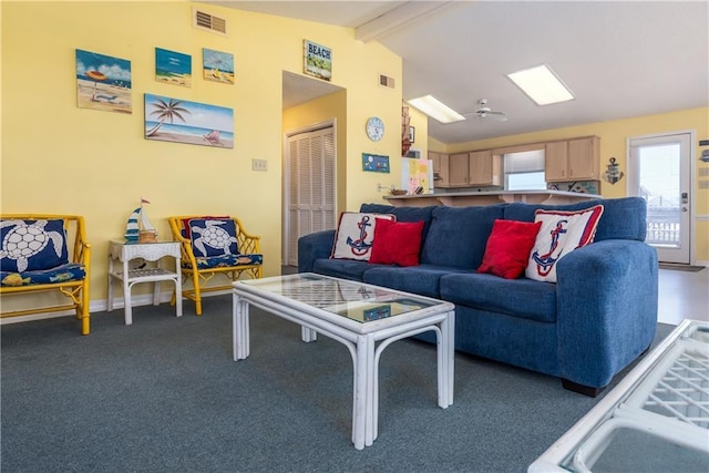 carpeted living room with visible vents, baseboards, and vaulted ceiling with beams