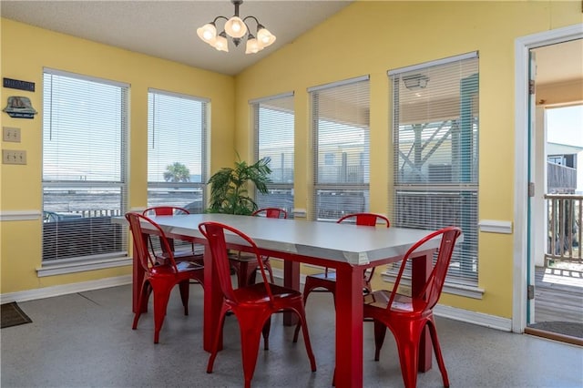 dining space featuring a chandelier, speckled floor, baseboards, and vaulted ceiling