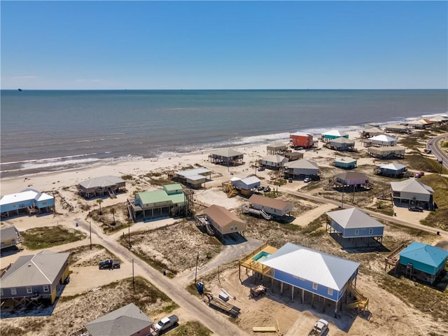 birds eye view of property with a view of the beach and a water view