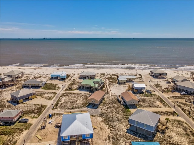 drone / aerial view featuring a water view and a view of the beach