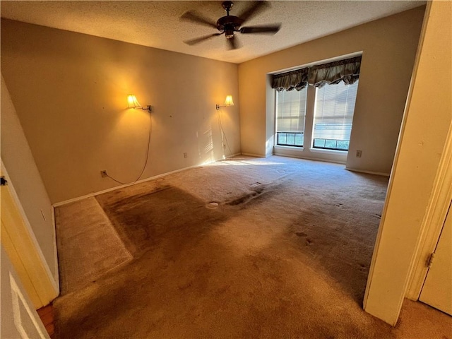 empty room featuring carpet flooring, a textured ceiling, and ceiling fan