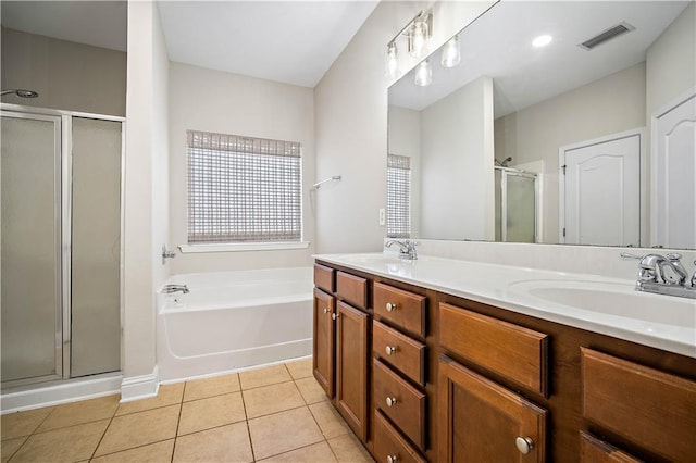 bathroom featuring tile patterned floors, visible vents, a shower stall, and a sink