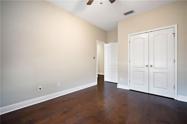 unfurnished bedroom with visible vents, ceiling fan, baseboards, dark wood finished floors, and a closet