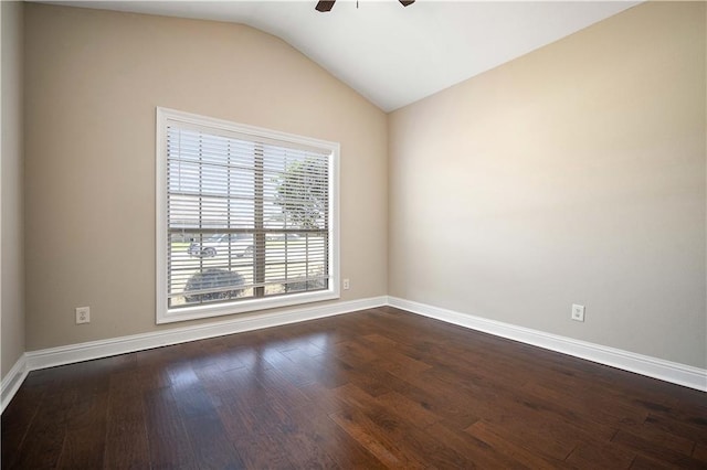 unfurnished room with baseboards, ceiling fan, dark wood-style flooring, and vaulted ceiling