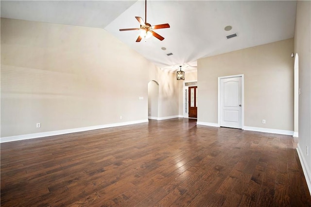 spare room featuring visible vents, baseboards, ceiling fan, dark wood-style floors, and arched walkways