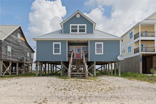 2344 Island Shores Dr, Dauphin Island, AL 36528 - raised beach house featuring a carport, stairway, a porch, and metal roof