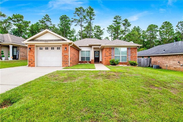 ranch-style house featuring a garage, central AC unit, and a front yard