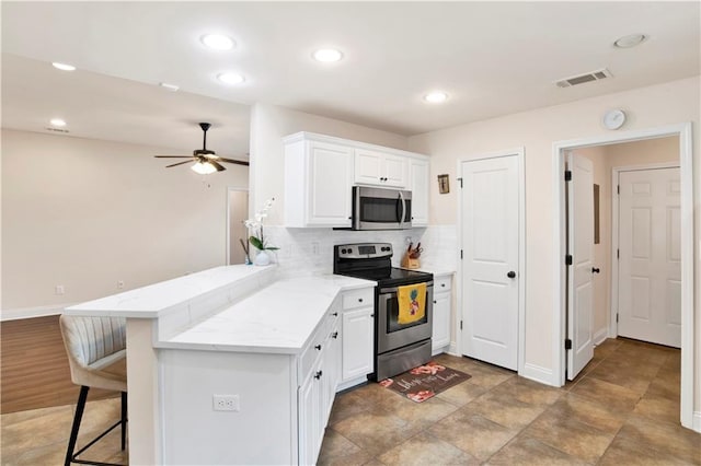 kitchen featuring visible vents, a peninsula, white cabinets, appliances with stainless steel finishes, and tasteful backsplash