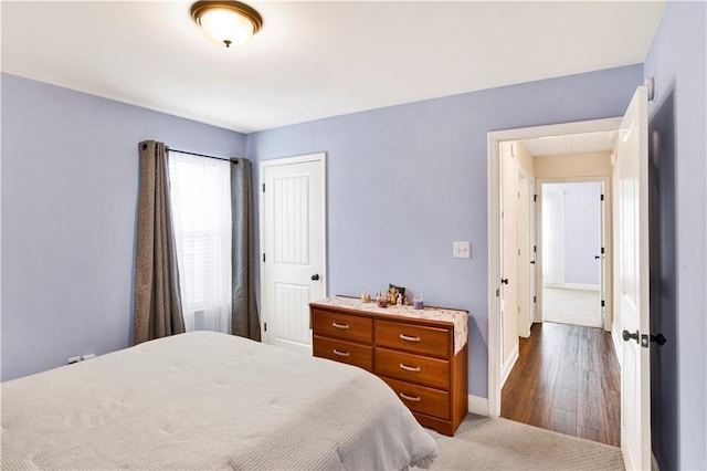 bedroom with a closet and baseboards