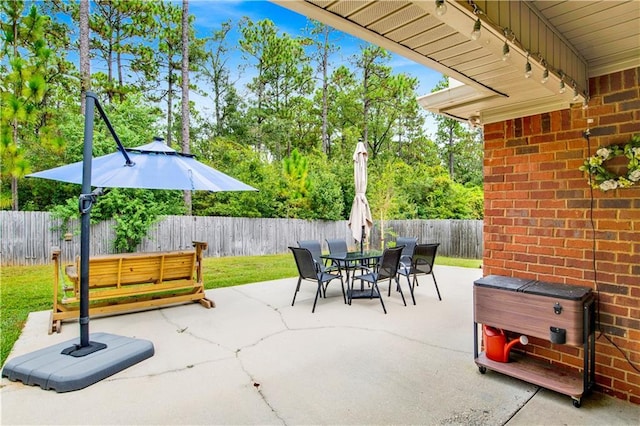 view of patio featuring outdoor dining space and a fenced backyard