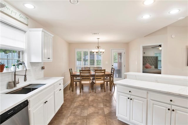 kitchen featuring a sink, visible vents, stainless steel dishwasher, and a wealth of natural light