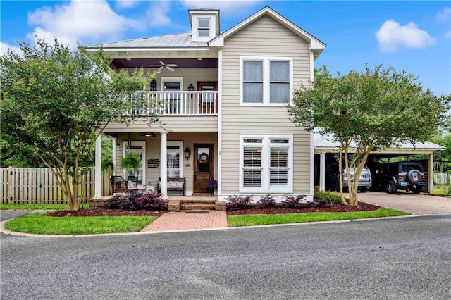 view of front of property with a porch, a balcony, and a carport