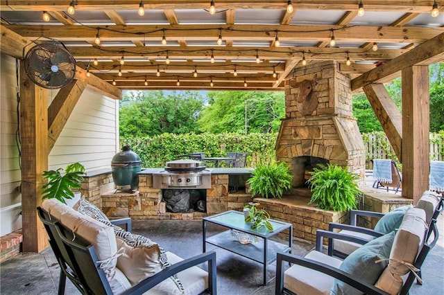 view of patio with grilling area and an outdoor living space with a fireplace