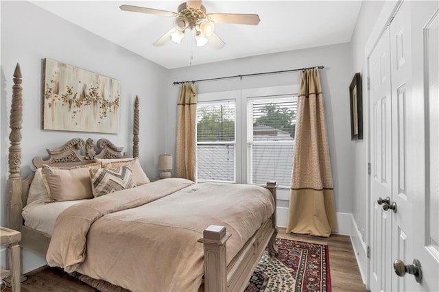 bedroom featuring hardwood / wood-style flooring, ceiling fan, and a closet