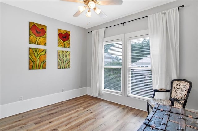 living area featuring ceiling fan and light wood-type flooring