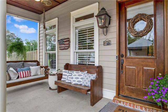 view of exterior entry with a porch