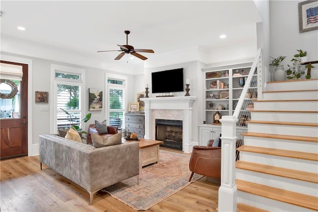 living room featuring ceiling fan and light hardwood / wood-style floors