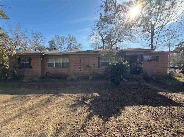 rear view of property featuring a lawn