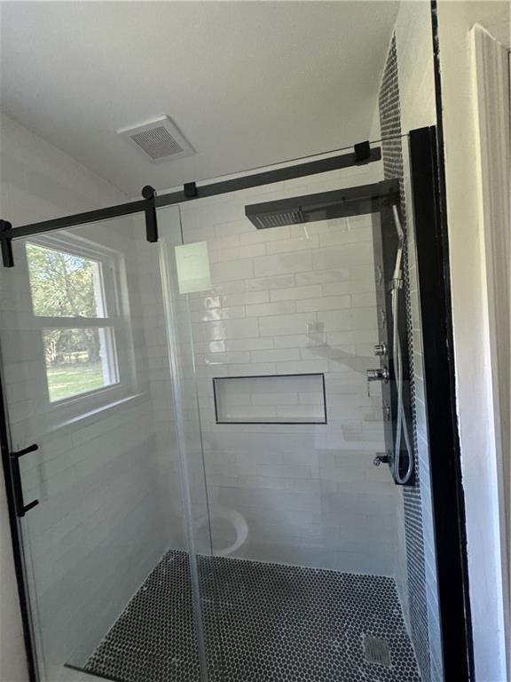 bathroom with an enclosed shower