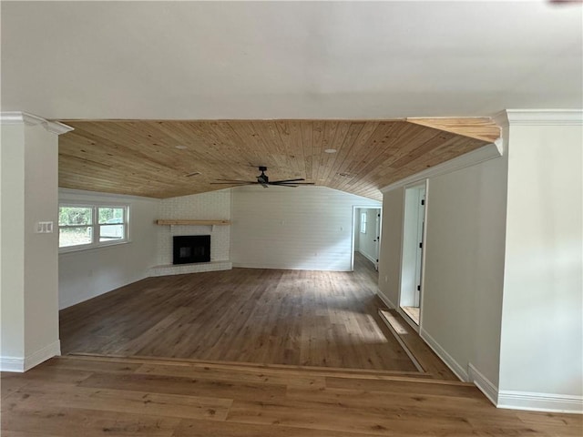 unfurnished living room with lofted ceiling, a brick fireplace, ceiling fan, wood ceiling, and wood-type flooring