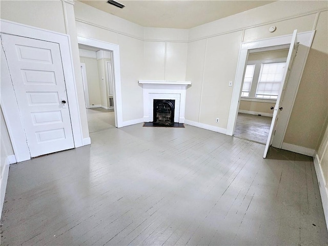 unfurnished living room with wood-type flooring