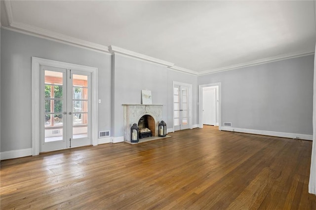 2007 Levert Dr N, Mobile, AL 36607 - unfurnished living room featuring french doors, wood finished floors, ornamental molding, and a fireplace