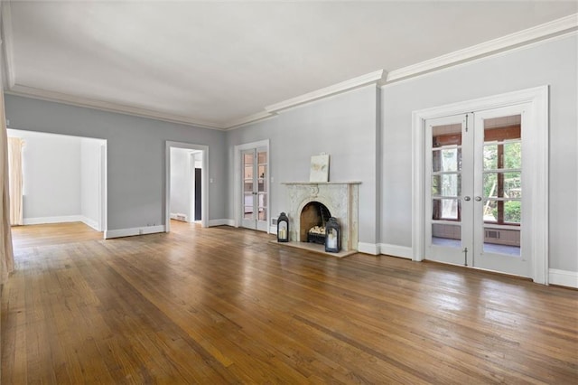 2007 Levert Dr N, Mobile, AL 36607 - unfurnished living room featuring french doors, ornamental molding, a premium fireplace, baseboards, and wood finished floors