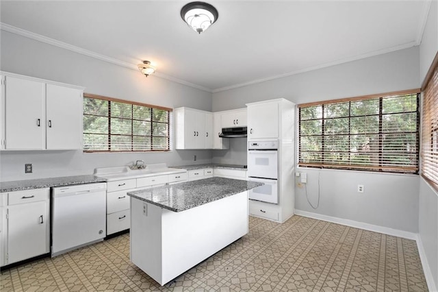 2007 Levert Dr N, Mobile, AL 36607 - kitchen featuring white appliances, under cabinet range hood, white cabinets, a kitchen island, and ornamental molding