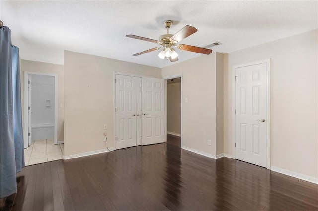 unfurnished bedroom with baseboards, visible vents, and wood finished floors