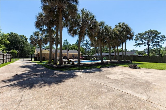 view of home's community featuring fence and a swimming pool