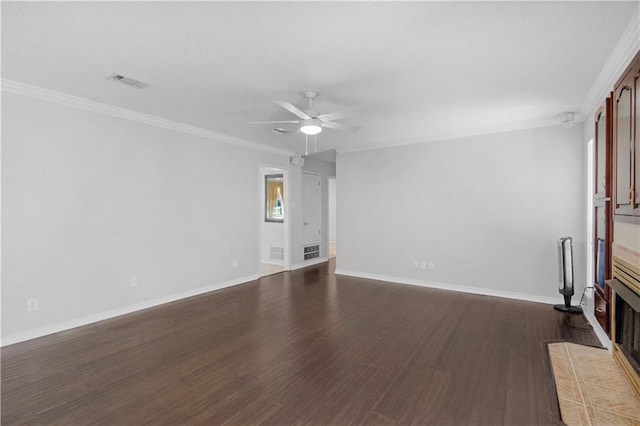 unfurnished living room featuring a ceiling fan, crown molding, dark wood finished floors, visible vents, and baseboards