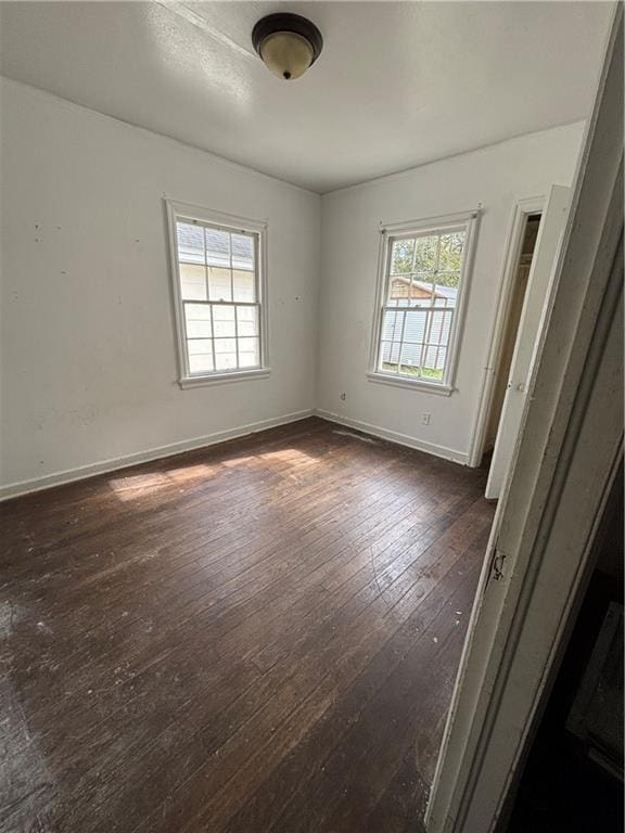 spare room with dark hardwood / wood-style floors