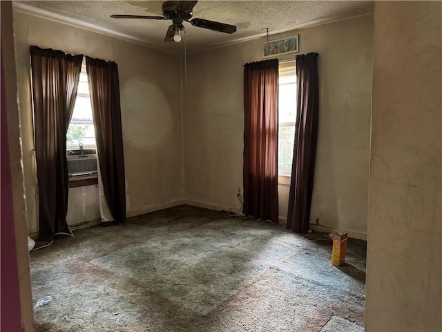 spare room with carpet flooring, a textured ceiling, and ceiling fan