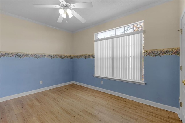 empty room with ornamental molding, ceiling fan, and light hardwood / wood-style floors