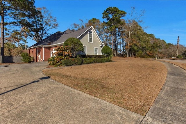 view of side of home with a lawn