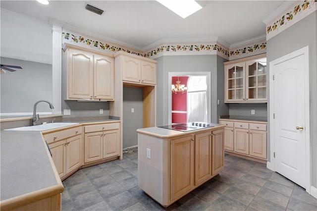 kitchen featuring sink, light brown cabinetry, black electric cooktop, and kitchen peninsula