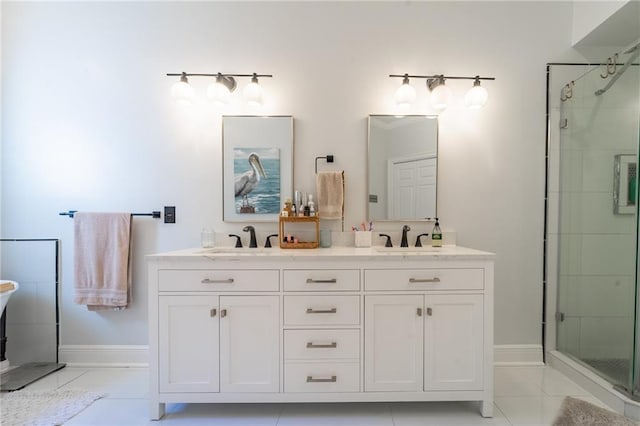 full bathroom featuring a shower stall, double vanity, a sink, and baseboards