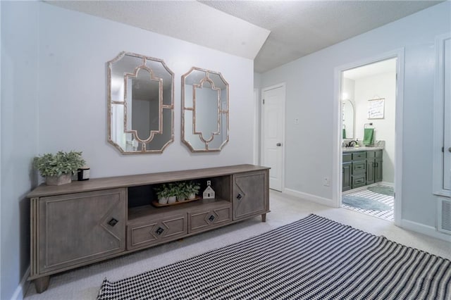 interior space with light colored carpet, baseboards, and visible vents