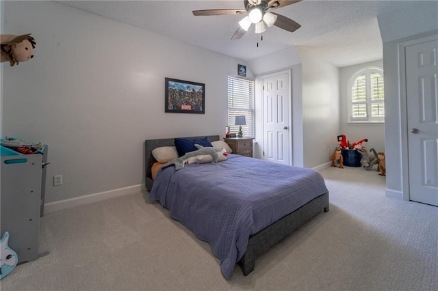 bedroom with baseboards, a ceiling fan, and light colored carpet